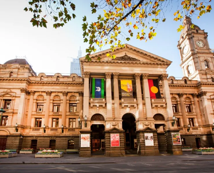 The front of Melbourne Town Hall, captured from Swanston Street. The Torres Strait Flag and Aboriginal Flag adorn the portico.